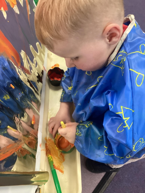 A child mixes some paint